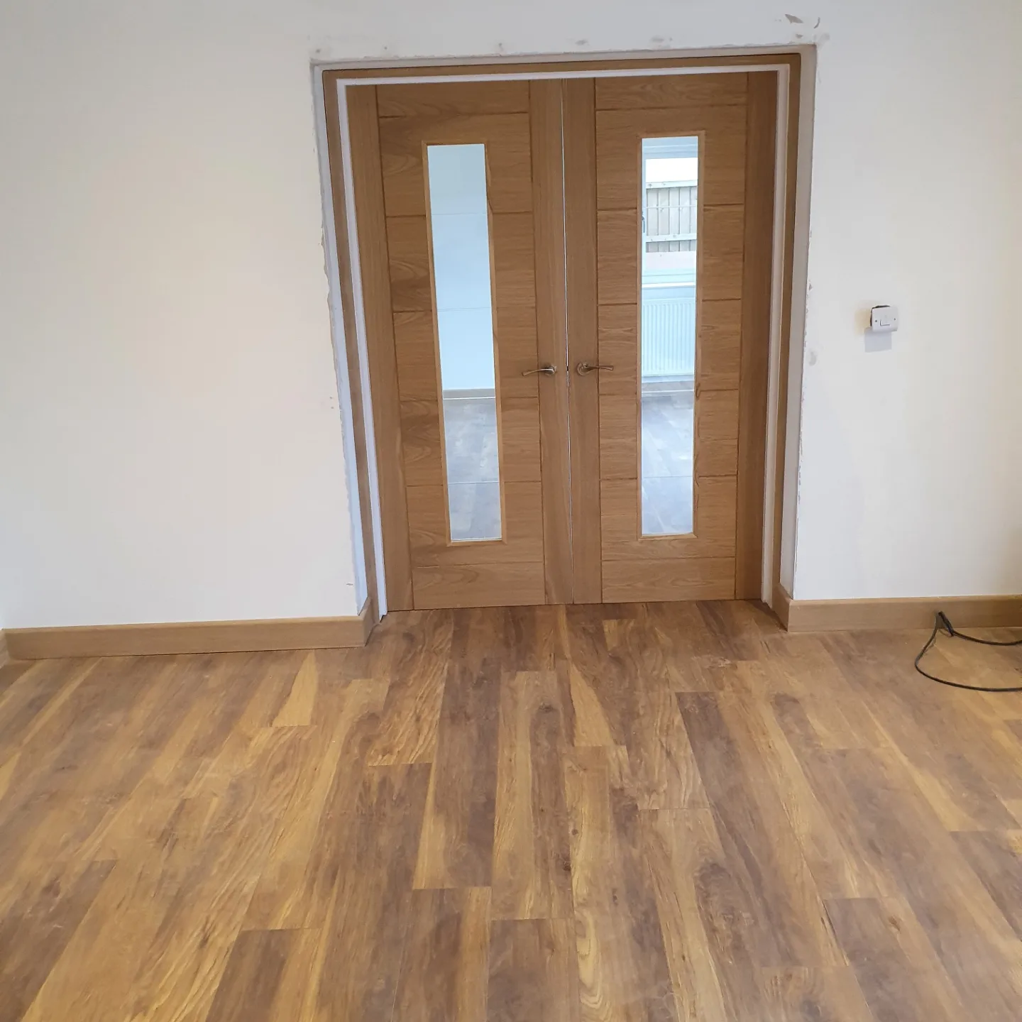 Oak double doors with glazed panels fitted between two rooms
